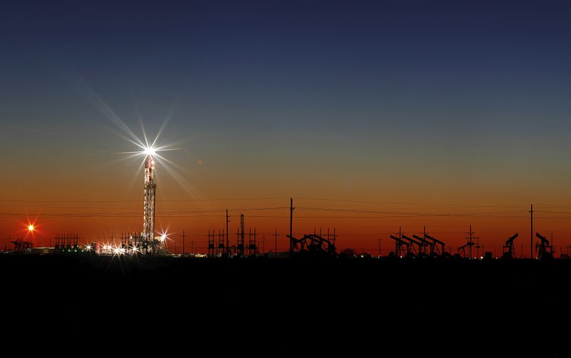 An oil rig lights up the horizon on the outskirts of Midland, Texas after a late sunset, April 2, 2020. (Photo- AP)  .jpeg