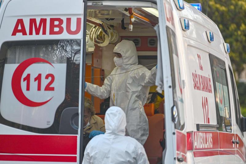 First-aid-workers-wearing-protectional-equipment-looks-after-a-woman-suspected-of-being-infected-with-COVID-19-as-she-is-evacuated-by-ambulance-on-April-12-2020-in-Istanbul.jpg