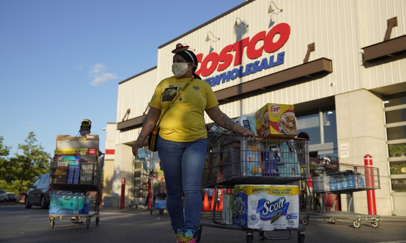 Customers carry their items after shopping at Costco in Washington D.C., the United States, May 5, 2021.(Photo: Xinhua)