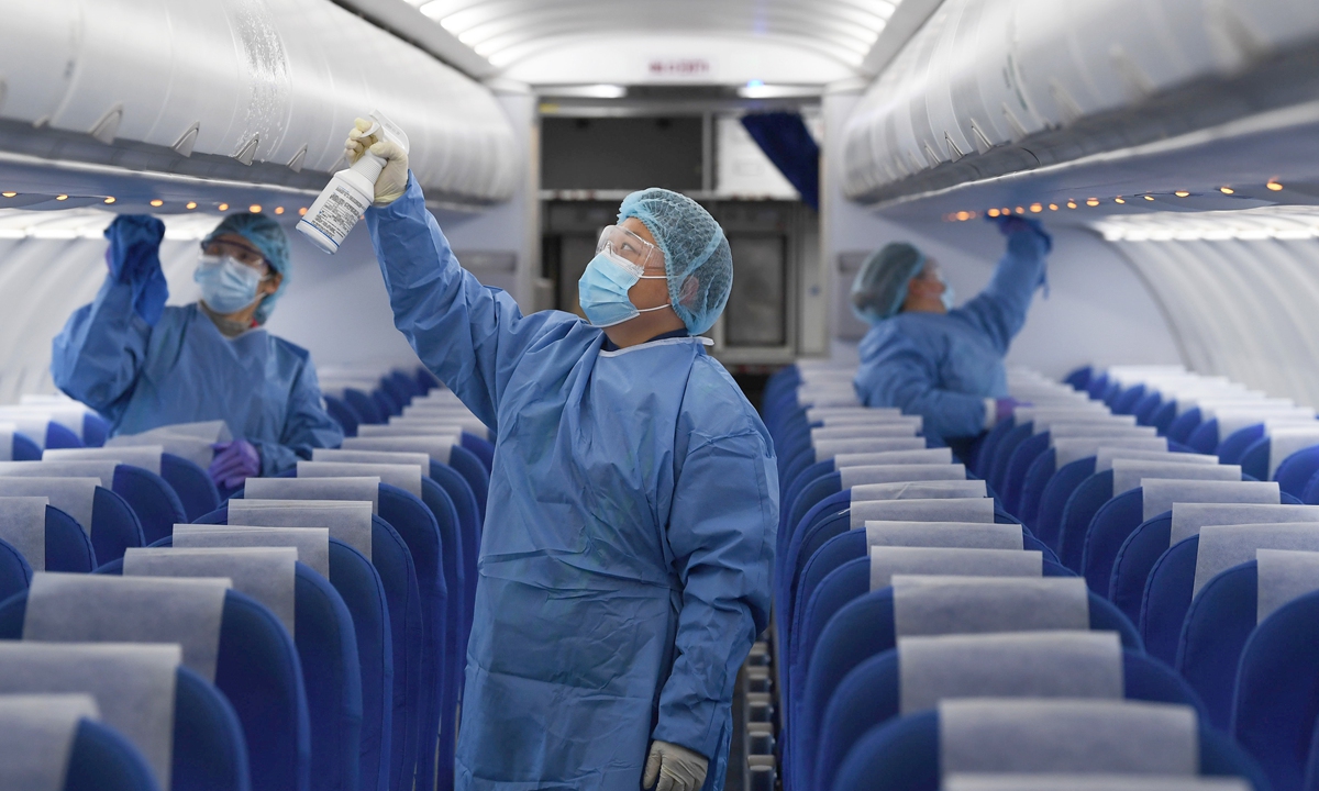 Ground service staff spray disinfectant through an aircraft cabin at Hefei Xinqiao International Airport, East China's Anhui Province on January 23, 2021. Photo:VCG