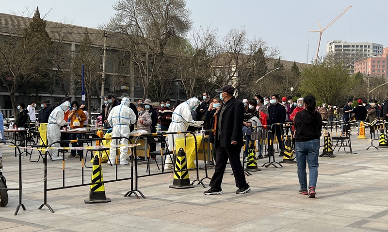 Residents from a local community in Beijing's Chaoyang district undergo nucleic acid testing on April 4th. Photo: CFP