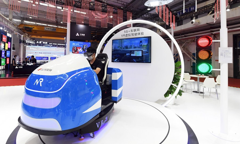 A media professional tries 5G-powered virtual driving during the 2021 World 5G Convention in Beijing, capital of China, Aug. 31, 2021.(Photo: Xinhua)