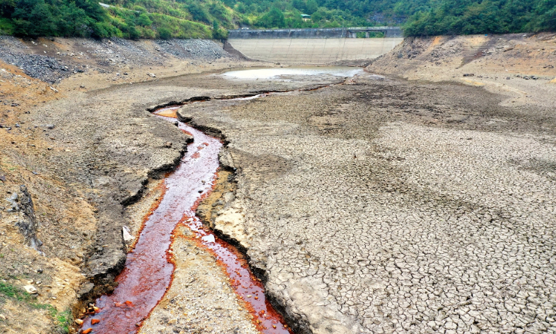 The photo taken on August 21, 2022 shows the Daxin Reservoir in Shizishan village, Suxian district in Chenzhou city, Hunan Province has dried up to the bottom.