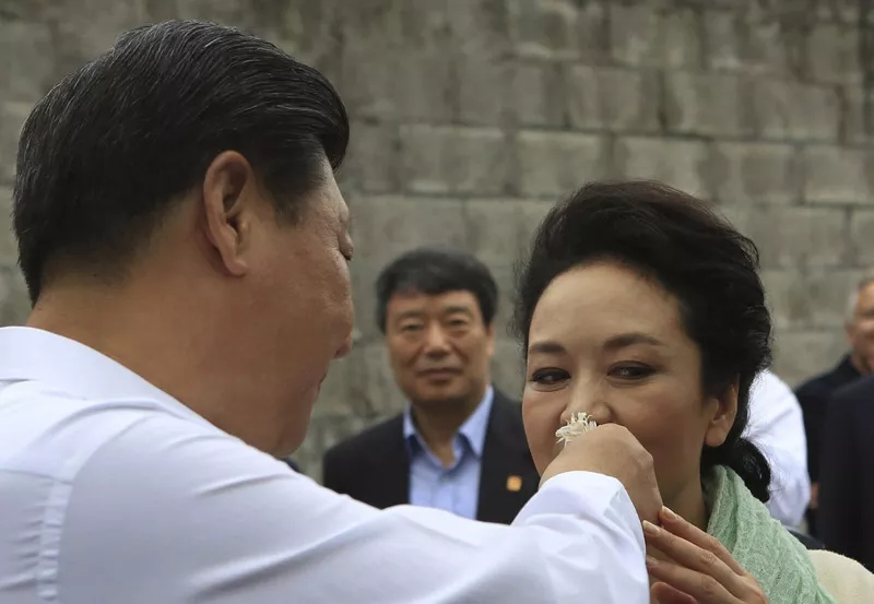 Xi Jinping and Peng Liyuan smell coffee flowers during their visit to a coffee farm in Costa Rica in June, 2013. [File Photo: CCTV]
