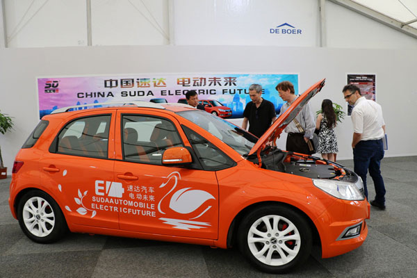 Visitors take a look at an electric vehicle produced by a Chinese firm displayed on the sidelines of the international cultural and economic exchange event "Blue Container on the New Silk Road" held in Duisberg, North Rhine-Westphalia, Germany. [Photo: China Plus]