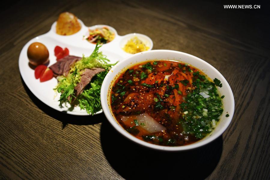 Photo taken on April 12, 2017 shows a package meal of beef noodle at a noodle restaurant in Lanzhou, capital of northwest China's Gansu Province. As a piece of name card of Lanzhou City, beef noodle is an indispensable food of local people. There are more than 1,000 beef noodle cookshops in Lanzhou and they can sell over one million bowls of beef noodle every day. [Photo: Xinhua]