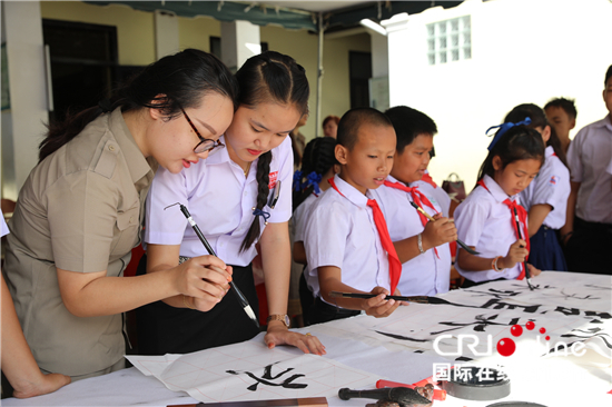 Students from Laos write brush calligraphy in Luang Prabang on Wednesday, July 4, 2018. [Photo: China Plus]
