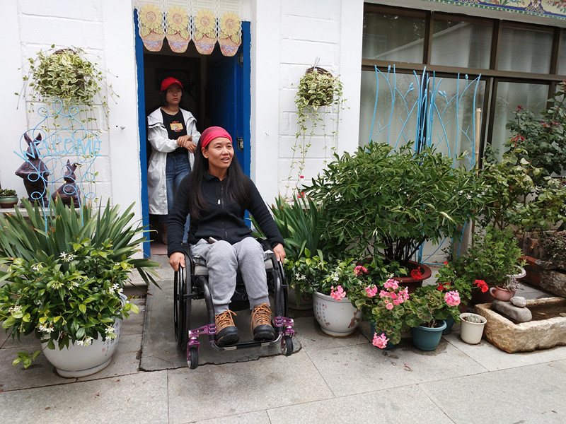 Lantian shows her guests the tricks of driving wheelchairs to educate them on the need for barrier-free facilities on July 19, 2018. [Photo: China Plus/Wang Lei]