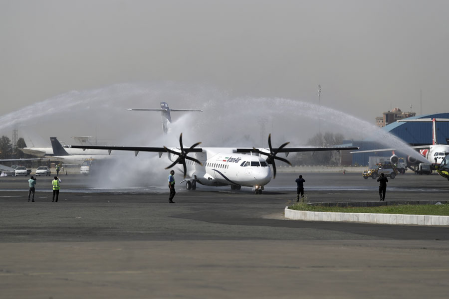 In this photo provided by Tasnim News Agency, a traditional water cannon salute welcomes an Iran Air's new commercial aircraft at Mehrabad airport in Tehran, Iran, Sunday, Aug. 5, 2018. Iran has acquired five new ATR72-600 airplanes from ATR, jointly owned by European consortium Airbus and Italy's Leonardo, a day before the U.S. begins restoring sanctions suspended under the 2015 nuclear deal. [Photo: Mohammad Hassanzadeh/Tasnim News Agency via AP]