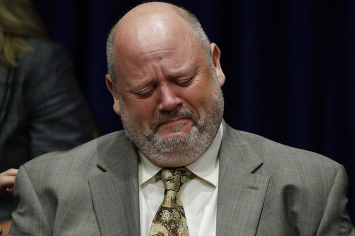Former priest James Faluszczak, who says he was molested by a priest as a teenager, reacts as Pennsylvania Attorney General Josh Shapiro speaks during a news conference at the Pennsylvania Capitol in Harrisburg, Pa., Tuesday, Aug. 14, 2018. A Pennsylvania grand jury says its investigation of clergy sexual abuse identified more than 1,000 child victims. The grand jury report released Tuesday says that number comes from records in six Roman Catholic dioceses. [Photo: AP /Matt Rourke]