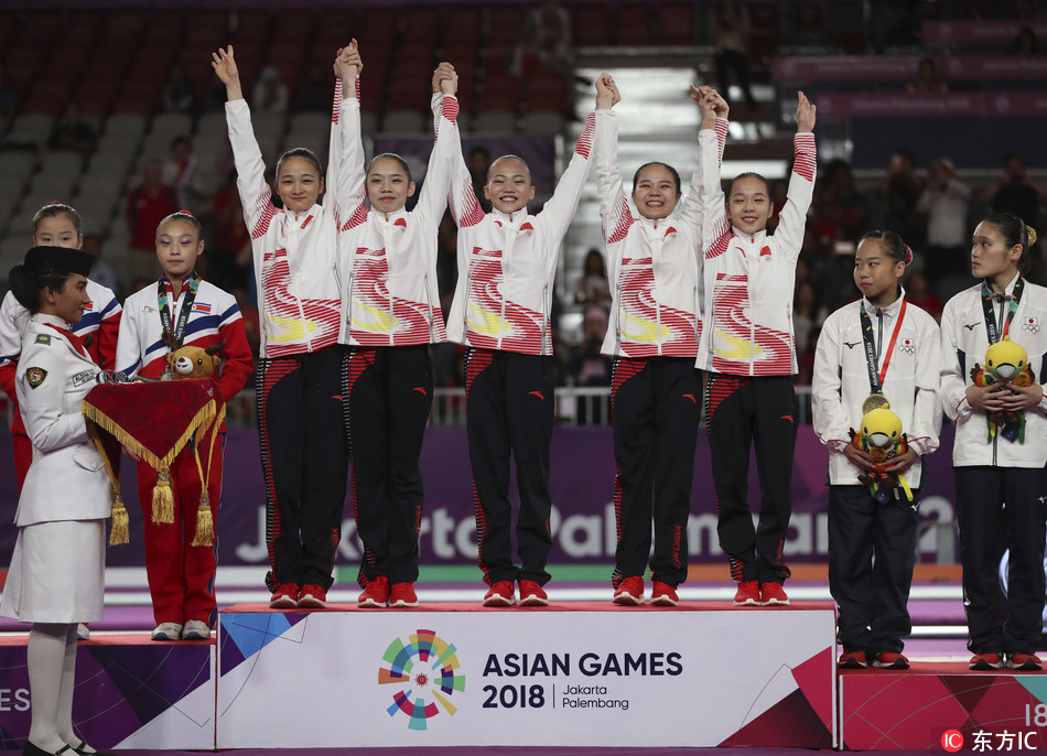 Members of team China celebrate with their gold medals after winning women's team gymnastics final at the 18th Asian Games in Jakarta, Indonesia, Wednesday, Aug. 22, 2018.[Photo: IC]