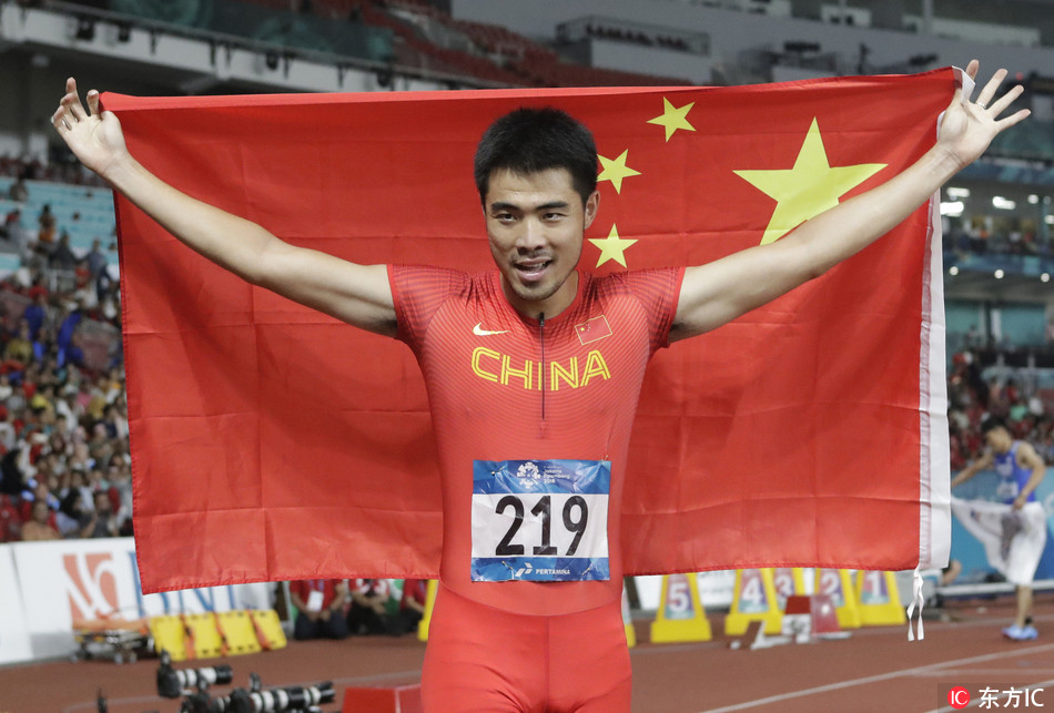 China's Xie Wenjun celebrates after winning the men's 110m hurdles final during the athletics competition at the 18th Asian Games in Jakarta, Indonesia, Tuesday, Aug. 28, 2018.[Photo: Lee Jin-man / IC]