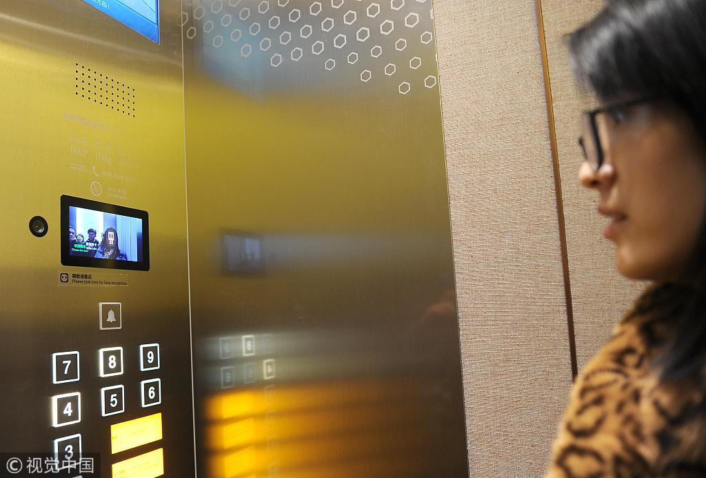 A guest scans her face to start the elevator at Alibaba's AI-driven "Flyzoo Hotel" in Hangzhou, Zhejiang Province, December 17, 2018. [Photo: VCG]