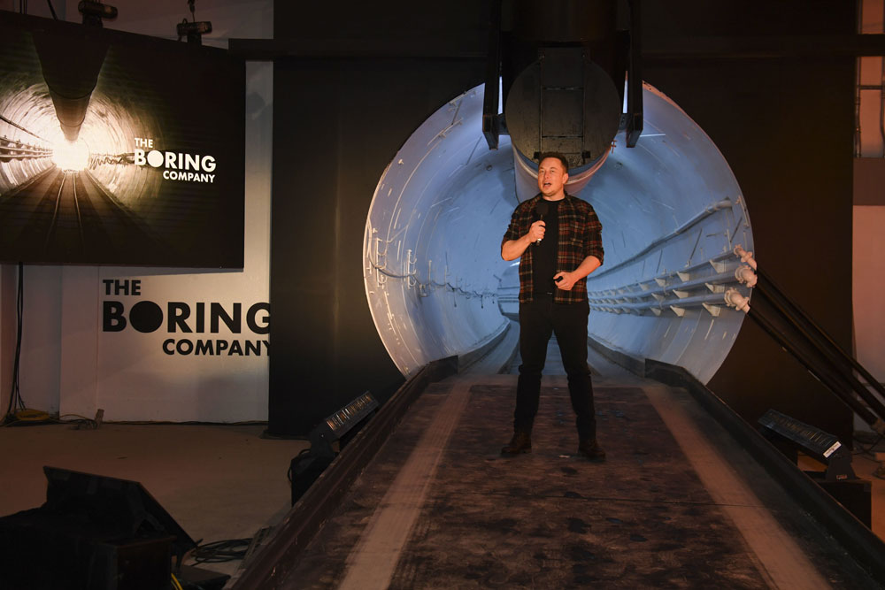 Elon Musk, co-founder and chief executive officer of Tesla Inc., speaks during an unveiling event for the Boring Co. Hawthorne test tunnel in Hawthorne, Calif., on Tuesday, Dec. 18, 2018. Elon Musk has unveiled his underground transportation tunnel, allowing reporters and VIPs to take some of the first rides in the subterranean tube, which the tech entrepreneur says is the answer to what he calls "soul-destroying traffic." [Photo:AP]