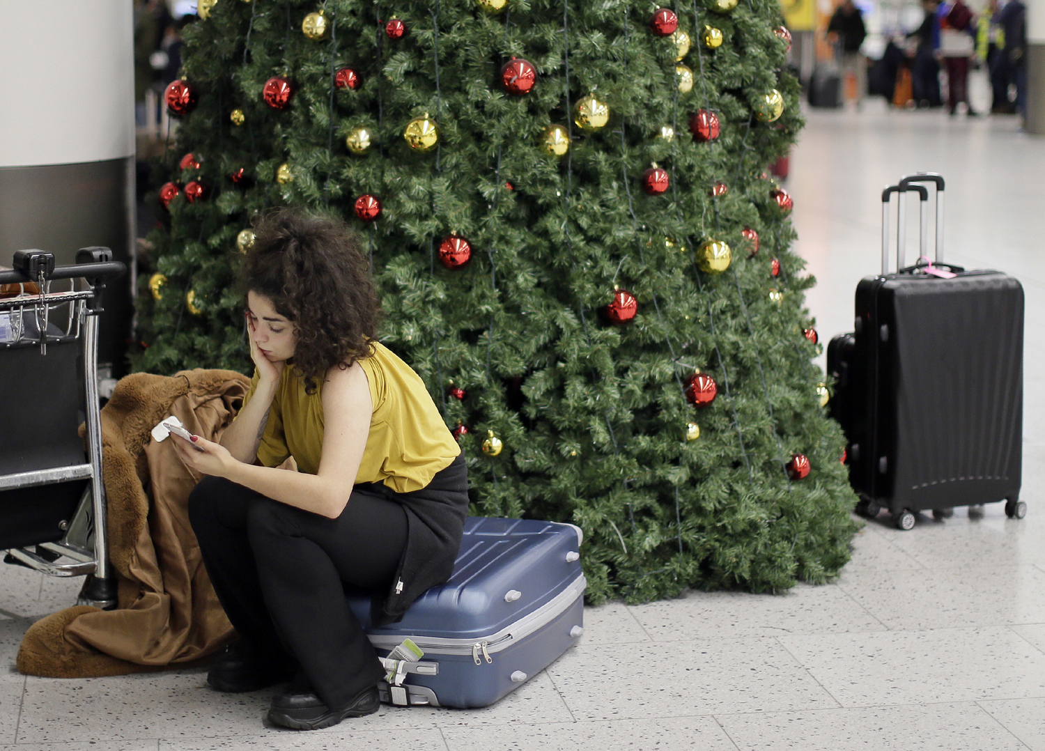 A woman waits in the departures area at Gatwick airport, near London, as the airport remains closed with incoming flights delayed or diverted to other airports, after drones were spotted over the airfield last night and this morning, Thursday, Dec. 20, 2018.[Photo: AP/Tim Ireland]
