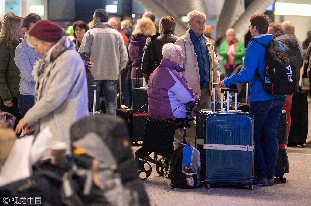Travellers wait for after flight cancellations during a one-day strike by security staff at Stuttgart's airport on January 10, 2019. [Photo: VCG]