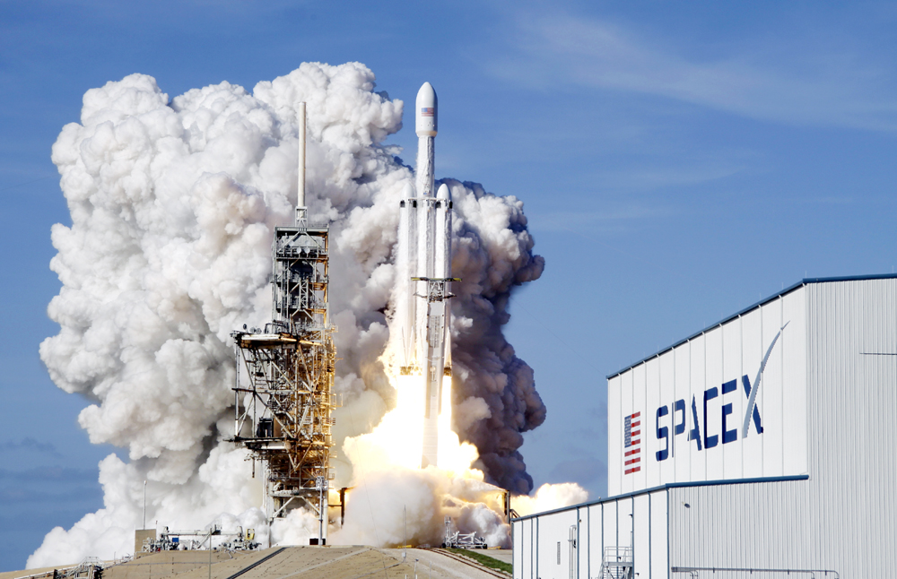 A Falcon 9 SpaceX heavy rocket lifts off from pad 39A at the Kennedy Space Center in Cape Canaveral, Fla., Feb. 6, 2018. [Photo: AP/John Raoux]