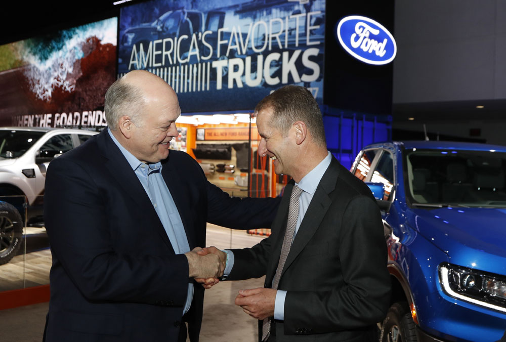 Ford Motor Co. President and CEO, Jim Hackett, left, meets with Dr. Herbert Diess, CEO of Volkswagen AG, Monday, Jan. 14, 2019, at the North American International Auto Show in Detroit. [Photo: AP/Carlos Osorio]
