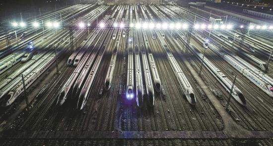 High-speed trains undergo maintenance in Guangzhou, Guangdong province, on Friday in preparation for the 2019 Spring Festival travel rush from Monday to March 1. Train travel is expected to increase by 8.3 percent this season. (Photo for China Daily/Lin Yuxian)