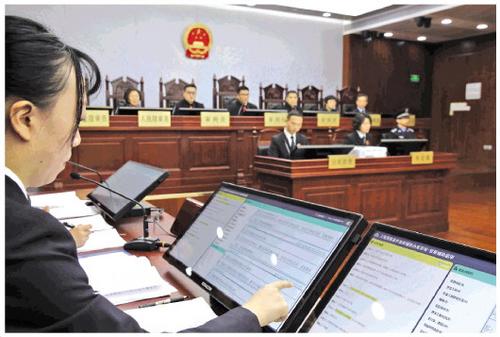 A public prosecutor reviews evidence presented by the AI system during a hearing at a Shanghai court on Wednesday, January 23, 2019. [Photo: Legal Daily]