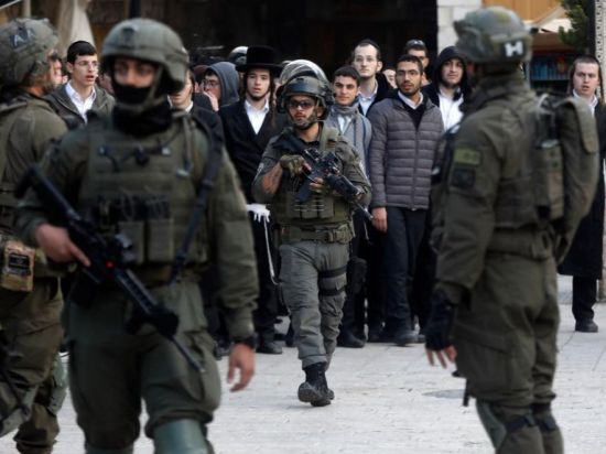Members of Israeli forces secure streets in West Bank city of Hebron