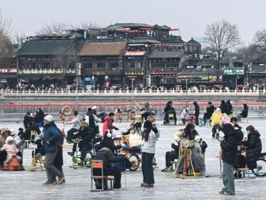 People play on frozen Shichahai lake in Beijing