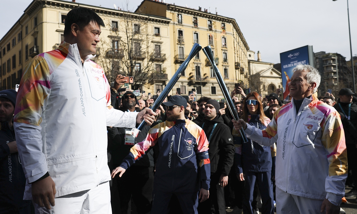 Former Chinese basketball legend Yao Ming and Coca-Cola CEO James Quincey relay the torch for 2026 Milan-Cortina Winter Olympics in Milan, Italy, February 6, 2026. Photo: Xinhua