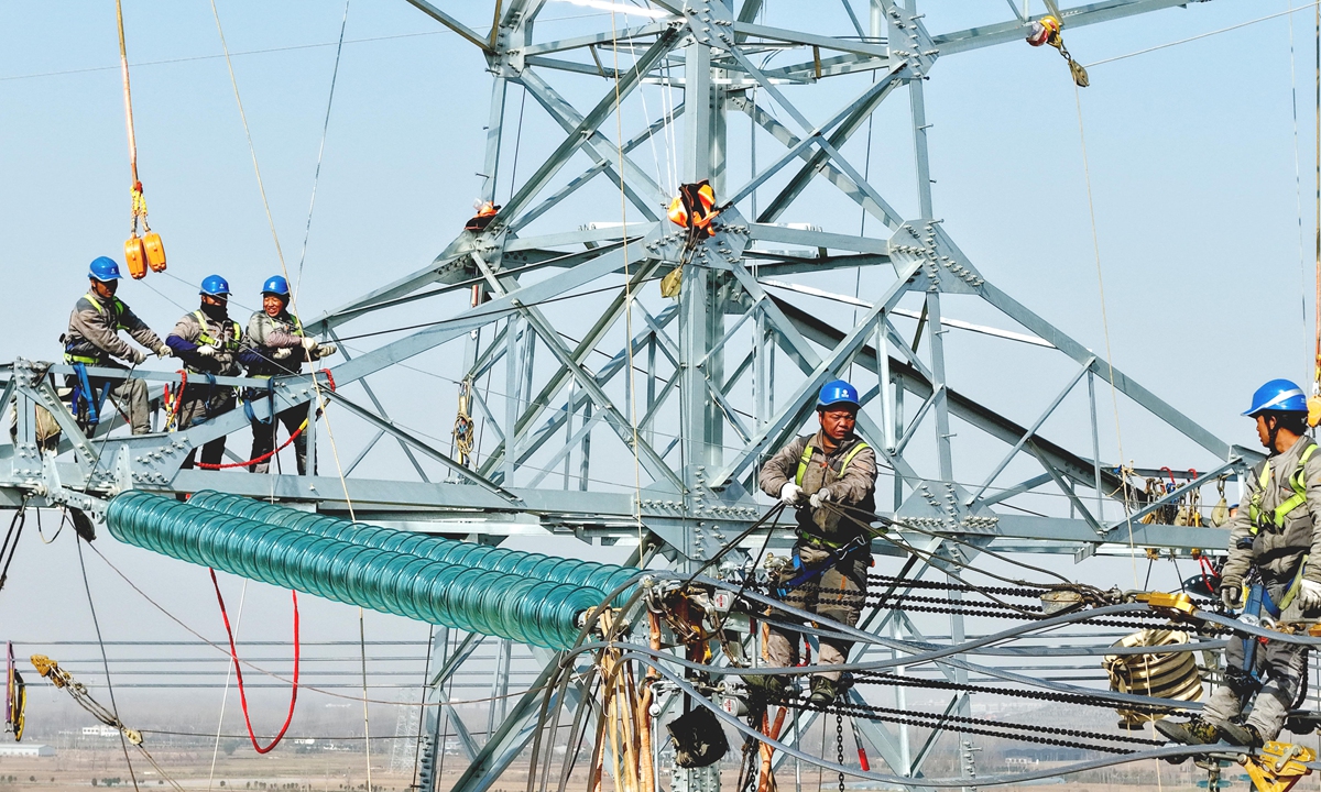 Technicians work on a 500-kilovolt power transmission line in Bozhou, East China's Anhui Province on November 24, 2025. Upon completion, the project will serve as a hub substation, and enhance the power supply capacity and reliability of the Bozhou region, providing a reliable electricity guarantee for Anhui's economic development. Photo: VCG