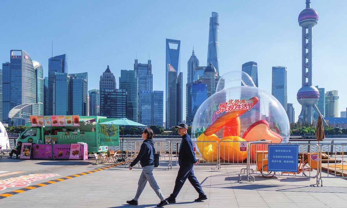 Pedestrians check out the splendid urban scenery on the North Bund of Shanghai on November 13, 2025. Photos on this page: VCG 