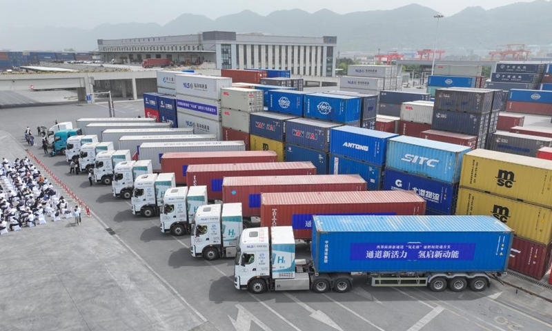 An aerial drone photo taken on April 14, 2025 shows hydrogen-powered heavy-duty trucks awaiting departure from the dry port of the New International Land-Sea Trade Corridor in Chongqing, southwest China. China's first cross-region hydrogen heavy-duty truck route was launched on Monday, marking a milestone in terms of advancing hydrogen energy development in China's western regions. The route, now operational for regular freight services via hydrogen-powered heavy-duty trucks, spans 1,150 kilometers from southwest China's Chongqing Municipality to Qinzhou Port in south China's Guangxi Zhuang Autonomous Region, passing through southwestern Guizhou Province. (Photo: Xinhua)