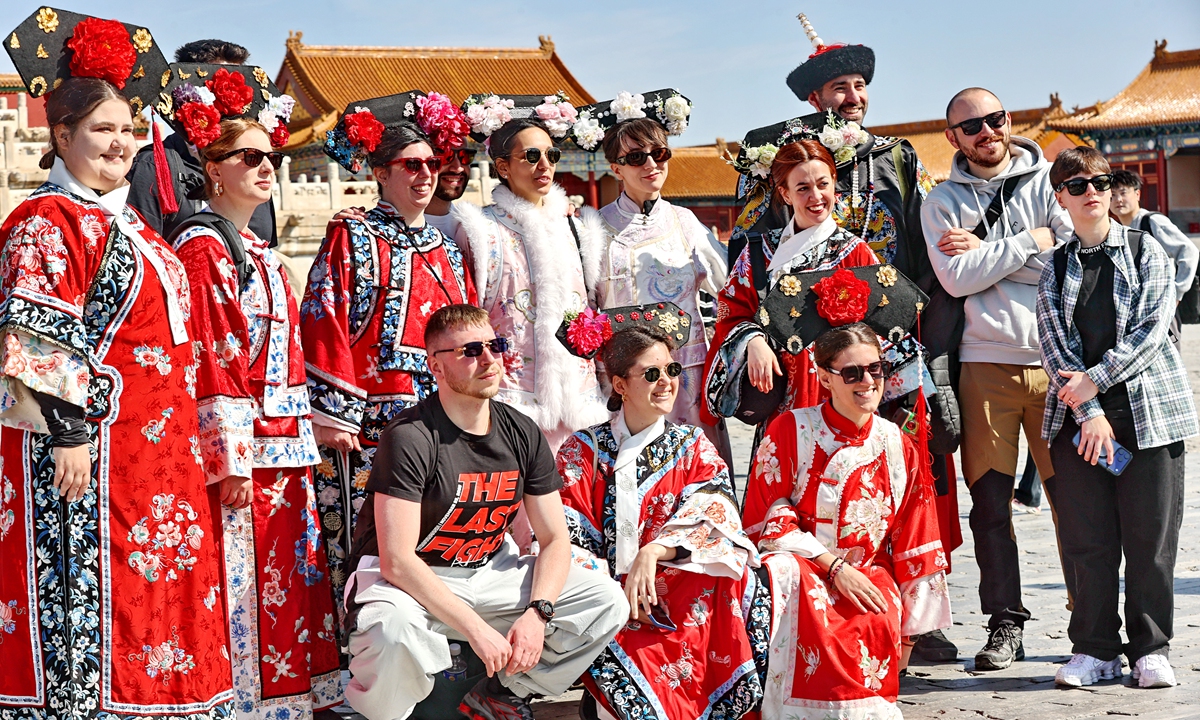 Foreign tourists dressed in ancient Chinese clothing pose for photos at the Palace Museum in Beijing on April 1, 2026. As China's visa-free policies continue to deliver benefits, a huge influx of foreign visitors has come to China, making the Palace Museum a top tourist destination. Photo: VCG