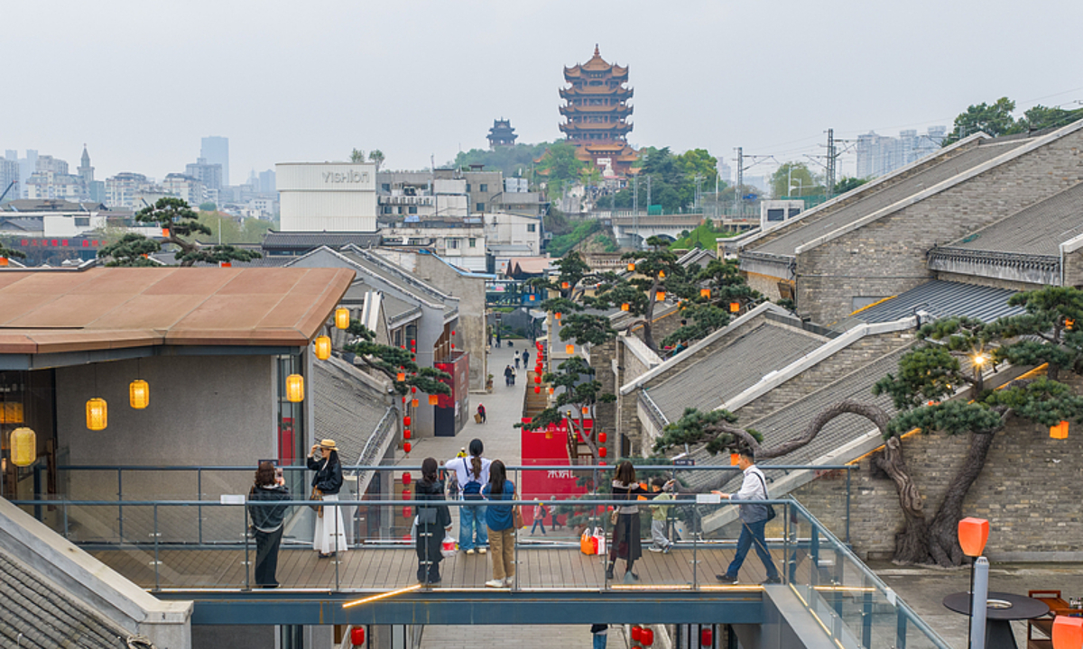 Tourists take pictures with Wuhan’s iconic Yellow Crane Tower on April 6, 2026. Photo: VCG
