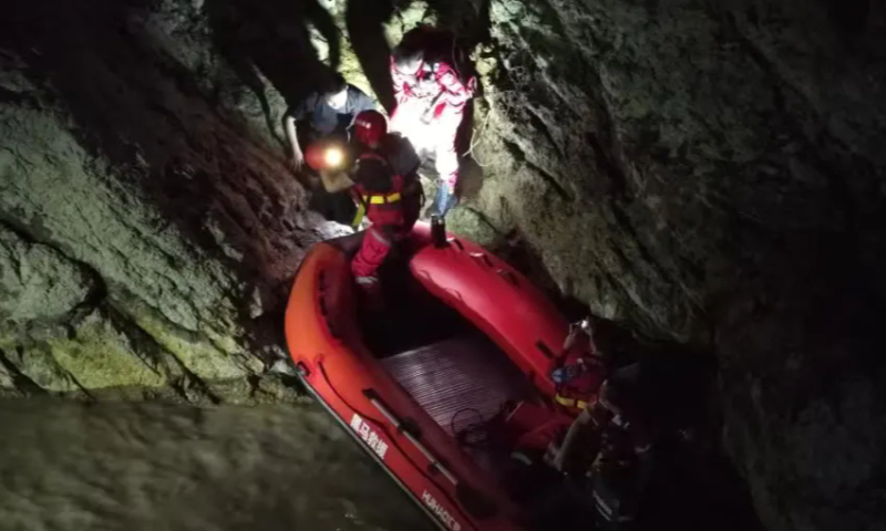 The boy is transferred onto a rescue boat and safely returned to shore. Photo: Longwan public security bureau