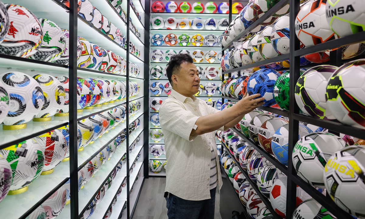 A Chinese vendor checks a football at the Yiwu International Trade Market in Yiwu, East China's Zhejiang Province on April 19, 2026. Photo: VCG
