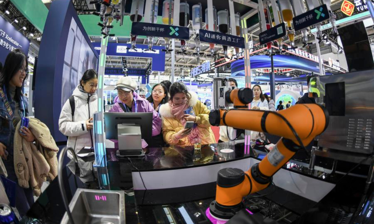 People view an AI-driven bartending system at the booth of Siemens in the Advanced Manufacturing Chain exhibition area of the second China International Supply Chain Expo in Beijing, capital of China, Nov. 27, 2024. (Xinhua/Zhang Haofu)