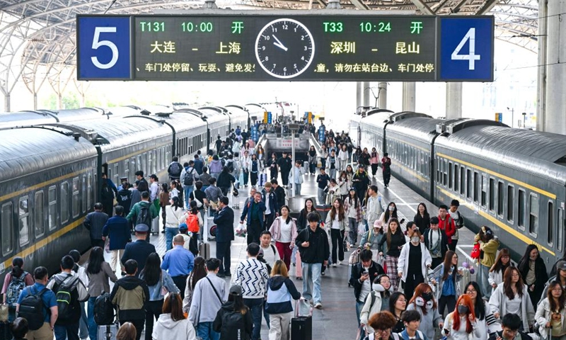 Passengers are seen at a platform of Nanjing Railway Station in Nanjing, east China's Jiangsu Province, May 1, 2026. The transportation network of the country witnessed a travel peak on the first day of the May Day holiday. (Photo by Yang Suping/Xinhua)