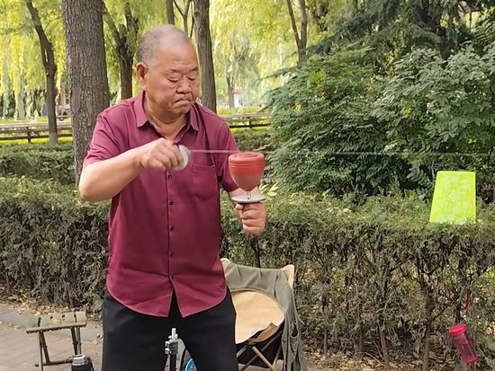Spinning top master sends it racing, nails its landing