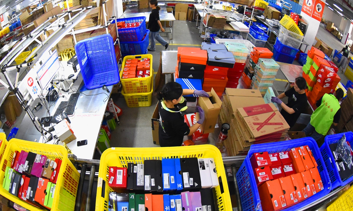Staff at an industry zone in Lianyungang, East China’s Jiangsu Province sort packages on Friday, the day China's major e-commerce platforms including JD and Alibaba's Tmall celebrate this year 618 mid-year shopping festival. Photo: VCG