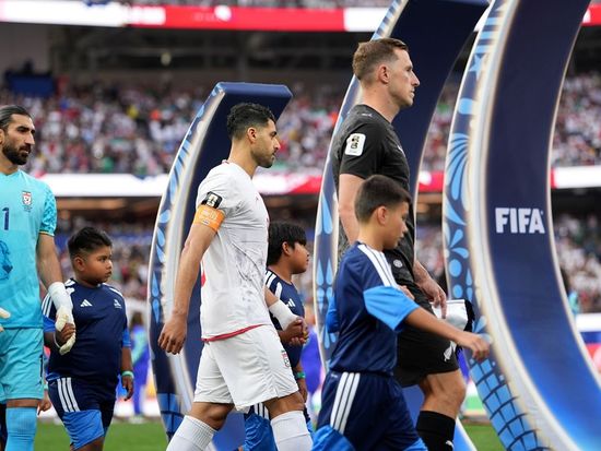 Iran coach hits out at FIFA after being forced to leave the US immediately following the opening match; FIFA president visits Iran’s national team