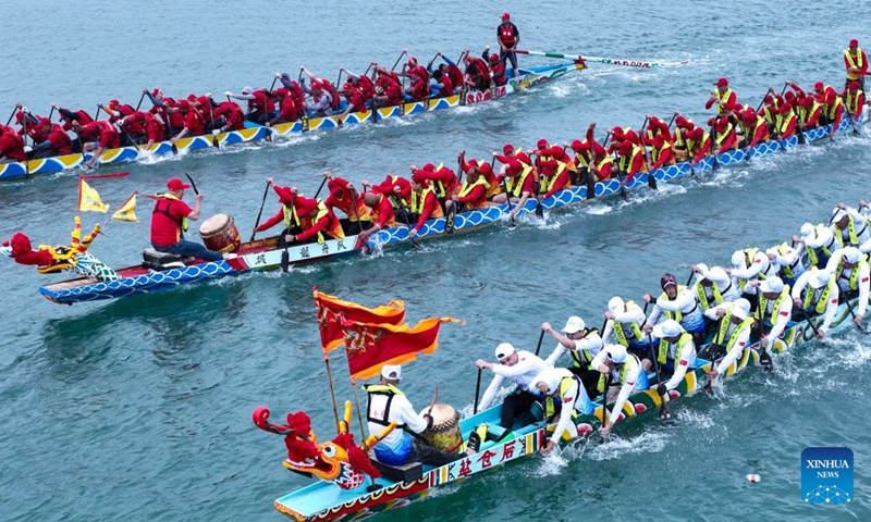 A drone photo taken on June 18, 2026 shows people competing in a dragon boat race in the sea areas of Tailu Town of Lianjiang County, Fuzhou of southeast China's Fujian Province. The Dragon Boat Festival, also known as Duanwu Festival, is a traditional Chinese holiday to commemorate ancient Chinese poet Qu Yuan from the Warring States Period (475-221 B.C.). Celebrated on the fifth day of the fifth month of the Chinese lunar calendar, the festival falls on June 19 this year. (Xinhua/Zhou Yi)