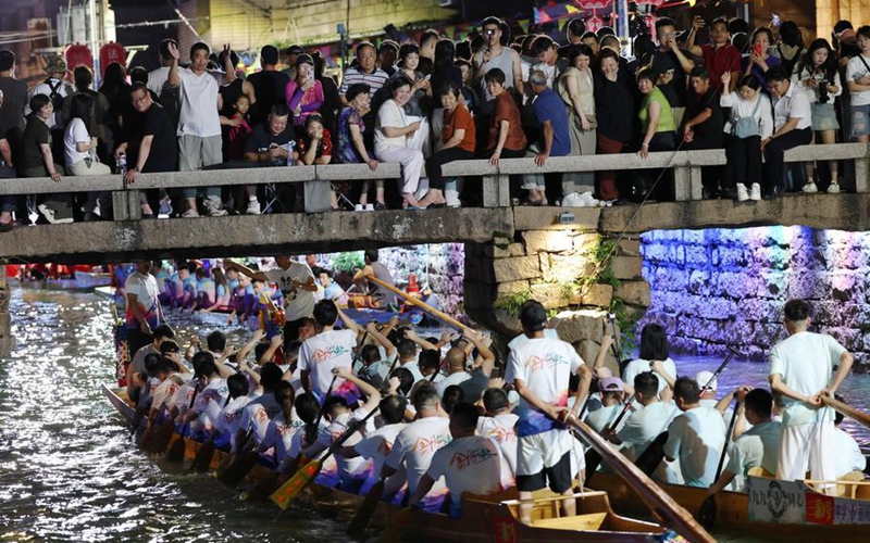 People take part in a nighttime dragon boat race to celebrate the Dragon Boat Festival in Sanxi Village of Changle District, Fuzhou, capital of southeast China's Fujian Province, June 18, 2026. The nighttime dragon boat race in Sanxi Village is a time-honored tradition. Every year around the Dragon Boat Festival, villagers gather to race after dark. The event carries deep cultural meaning and serves as a prayer for good harvests and well-being. (Xinhua/Jiang Kehong)