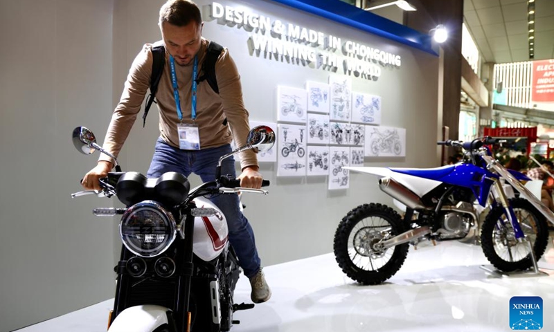 A visitor tries to ride a motorcycle of Chinese motorcycle maker ZXMOTO at the 139th edition of the China Import and Export Fair in Guangzhou, south China's Guangdong Province, April 17, 2026. The recent historic double victory by Chinese motorcycle maker ZXMOTO in the World Supersport category at the Portuguese round of the Superbike World Championship has drawn widespread attention. (Xinhua/Lu Hanxin)

