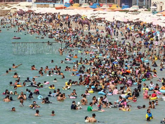 People cool off on beach during summer heatwave in Alexandria, Egypt
