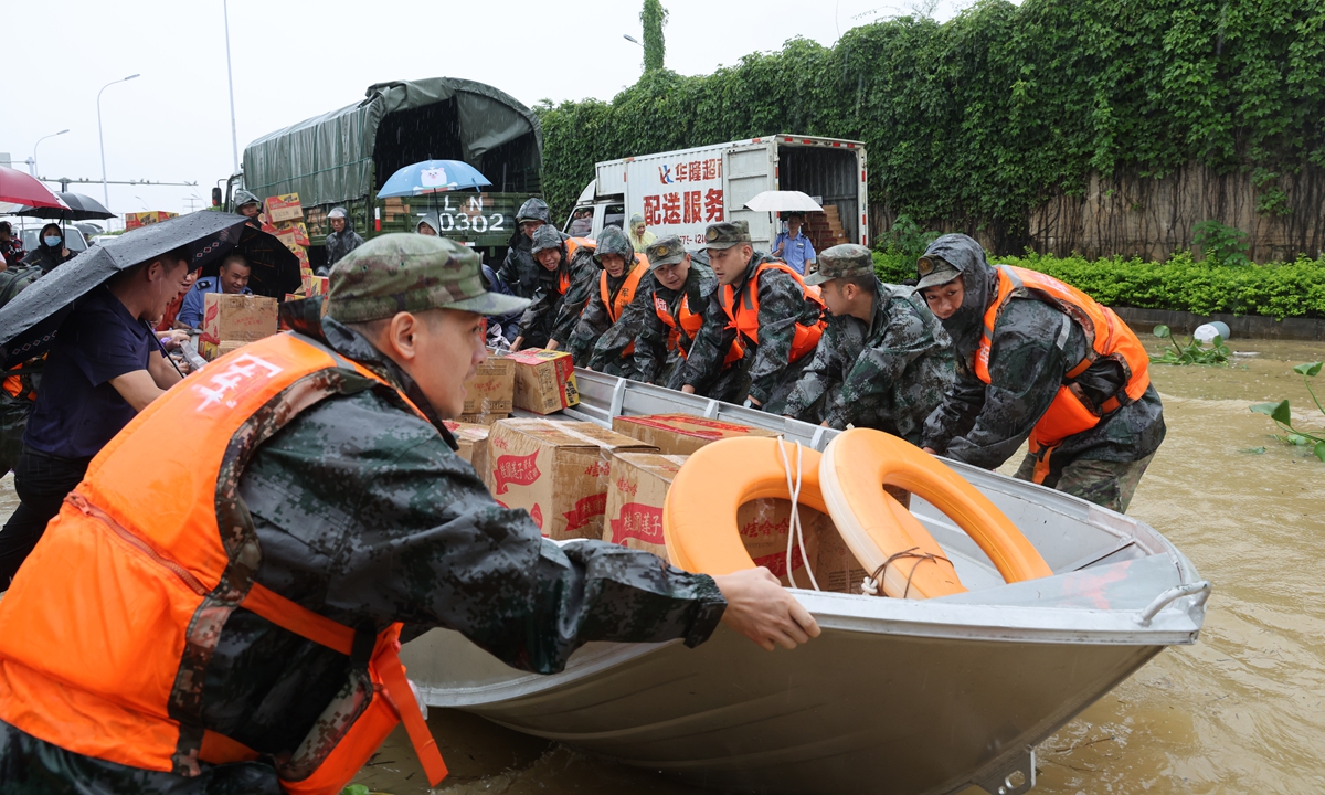 Military units, fire rescue personnel and volunteers work together to deliver emergency supplies to schools cut off by floods in Guigang, Guangxi Zhuang Autonomous Region, on July 7, 2026. Photo: IC