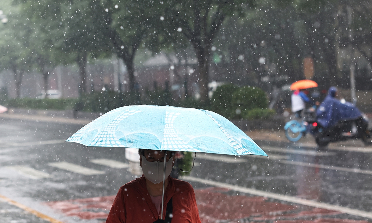 Residents in Beijing travel in the rain amid heavy rainfall on July 10, 2026. Photo: VCG
