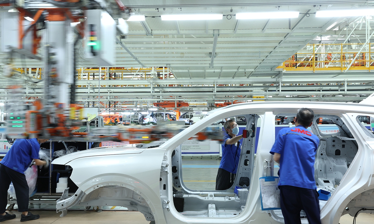 Workers operate in an orderly manner on the assembly line at the Fushan plant of Jiangling Motors Co., Ltd. (JMC) on July 13, 2026. Photo: VCG