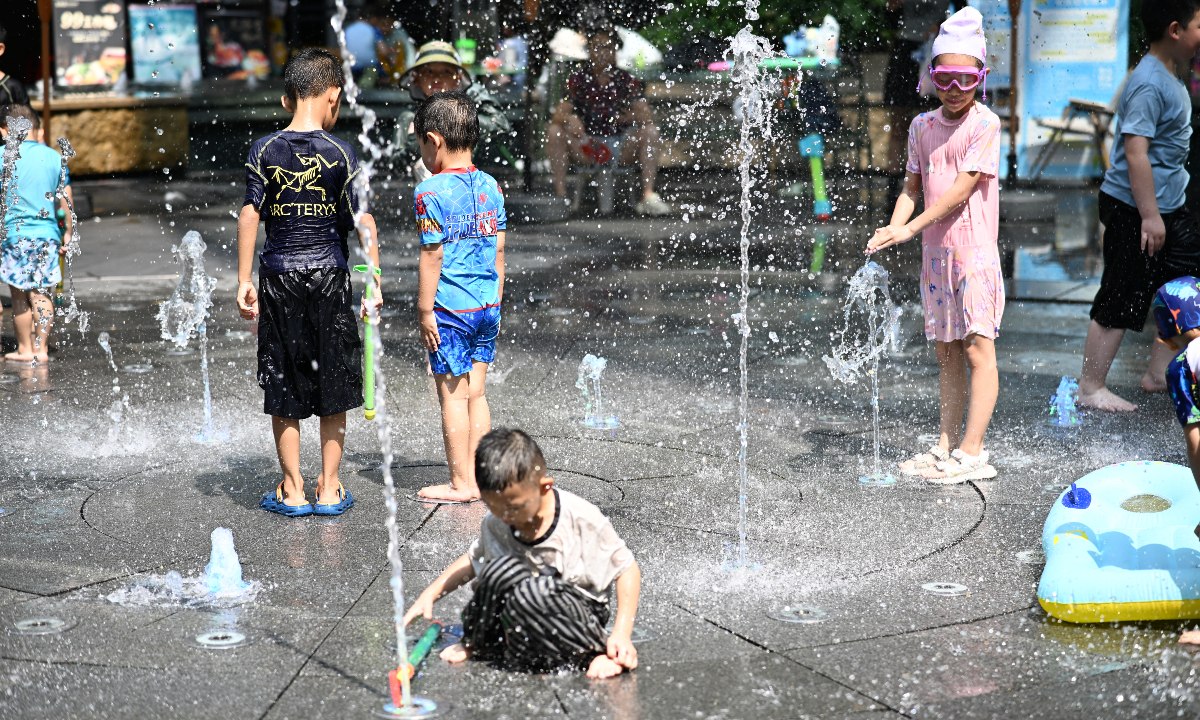Children cool off at a water-play area set up by a shopping mall in Chengdu, Southwest China’s Sichuan Province on July 15, 2026, the first day of sanfu, as the city endures high temperatures. 