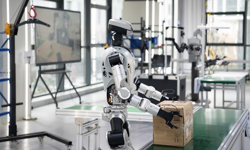 A humanoid robot conducts box-carrying training at a data collection pre-training center for humanoid robots in Hefei, east China's Anhui Province, Dec. 4, 2025. (Xinhua/Zhang Duan)