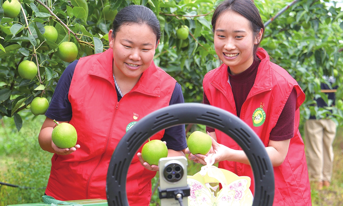 Young Party members live-stream to help farmers sell pears in a pear orchard in Zhouduo Village, Hai'an City, East China's Jiangsu Province, on July 1, 2026. Photo: VCG