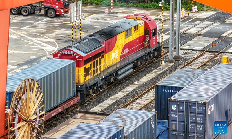 A drone photo taken on Sept. 13, 2025 shows a freight train bound for Central Asia loaded with auto parts, laptops and other goods waiting for departure at Tuanjiecun Station in Chongqing, southwest China. In the first eight months of this year, 35 freight trains have been dispatched from Chongqing to Central Asia, with a container volume of more than 3,000 TEUs and a total value of nearly 600 million yuan (about 84.2 million U.S. dollars), according to statistics from the Chongqing Railway Logistics Center. (Photo: Xinhua)